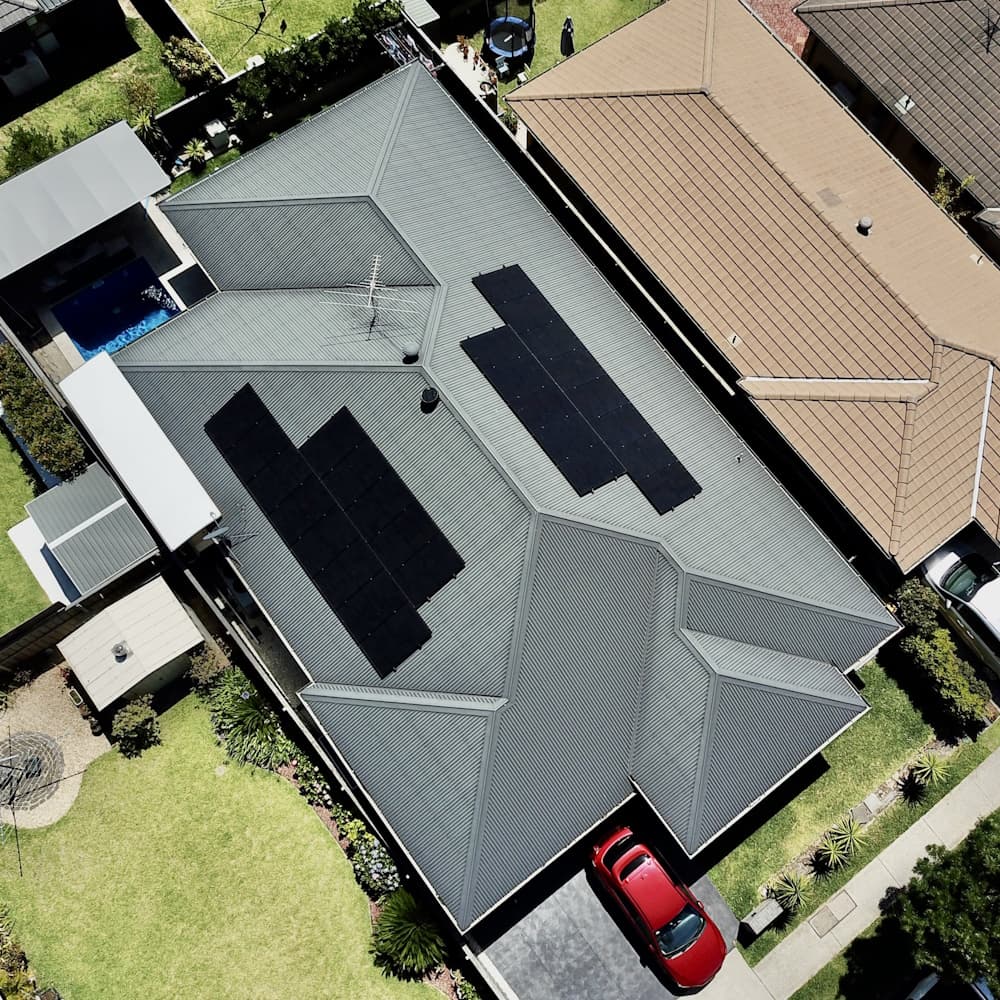 Solar panel installation with yellow logo overlay